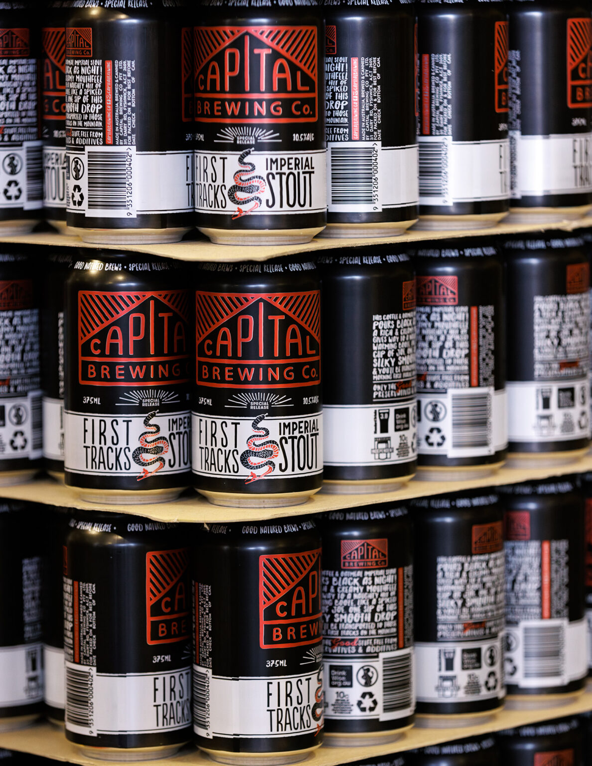Cans of First Tracks Imperial Stout stacked